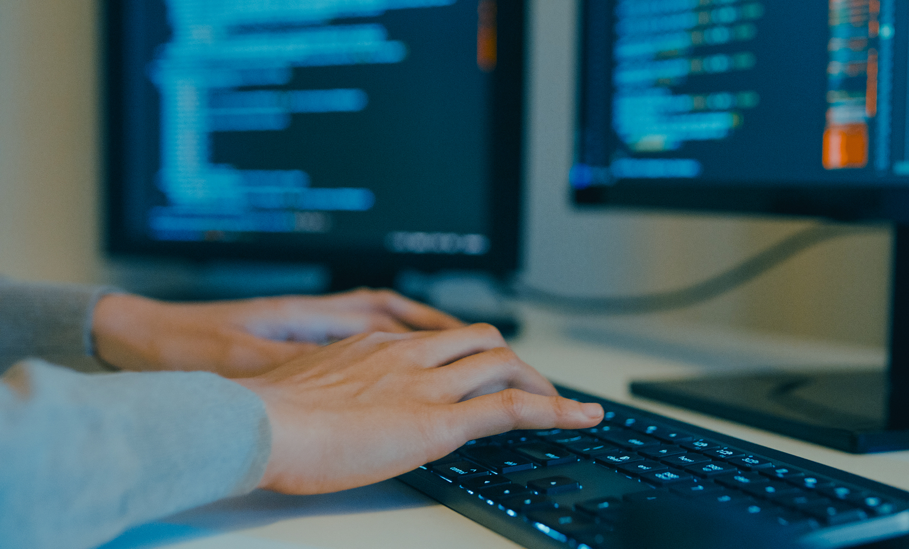 Closeup image of worker typing on computer